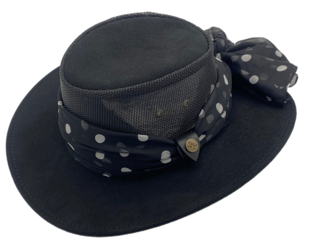 Black wide-brimmed hat with a polka dot print scarf on a white background
