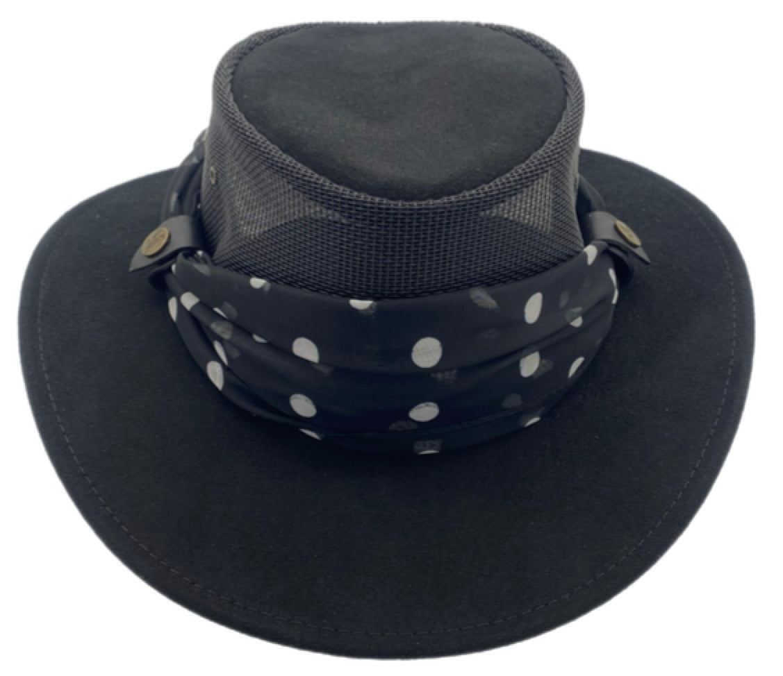 Black wide-brimmed hat with a polka dot print scarf on a white background