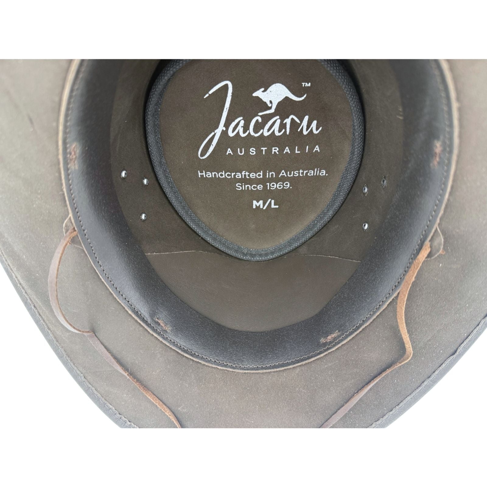 Gray leather hat with Jacaru Australia logo and text on a white background