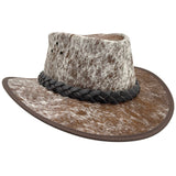 A Jacaru 1049 Rustler leather hat with a cowhide pattern and a braided leather band.