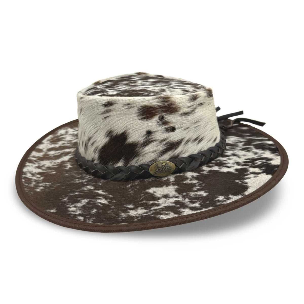 A Jacaru 1049 Rustler leather hat with a cowhide pattern and a braided leather band.