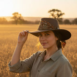 Woman wearing a Brown Kangaroo Ladies Breeze Hat in a field at sunset