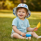 Jacaru 1895 kids whales bucket hat worn by toddler in sunny park.
