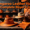 A wide-brim kangaroo leather hat with fine grain texture displayed on a wooden surface in natural outdoor lighting.