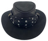 Black wide-brimmed hat with a polka dot print scarf on a white background