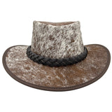 A Jacaru 1049 Rustler leather hat with a cowhide pattern and a braided leather band.