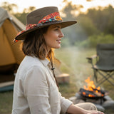 Woman Ladies Camper Hat with a colorful band, sitting by a campfire with a tent in the background.