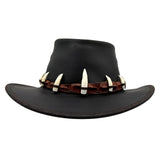 Black Wallaroo Croc Hat with a brown band and white tusk decorations on a white background