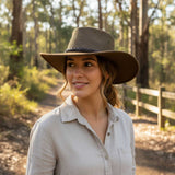 Woman wearing a A brown Jacaru 1066 Rizon Soft Hat in a forest setting