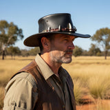 Man wearing a leather Croc Hunter Hat with spikes in an outdoor setting