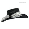 Black wide-brimmed hat with a white scarf with black polka dots on a white background