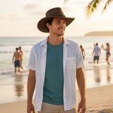 Man Soaker Breeze Hat on a beach with people in the background