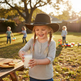 A young girl is wearing a brown Children's Hat, a light grey long-sleeved shirt.