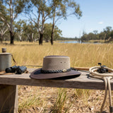 Jacaru Brown The Aussie Breeze Hat on a bench with fishing gear in the outback.