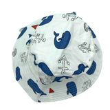 Jacaru 1895 white bucket hat with blue whale, anchor, and red sailboat print viewed from top showing stitched brim.